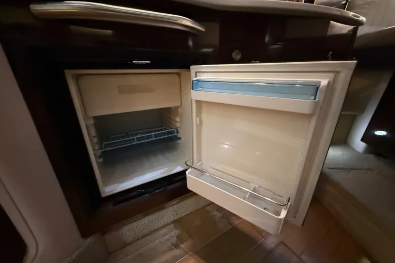  Yacht Photos Pics Open refrigerator inside 2017 Sea Ray Sundancer 330 yacht, showcasing interior storage space.