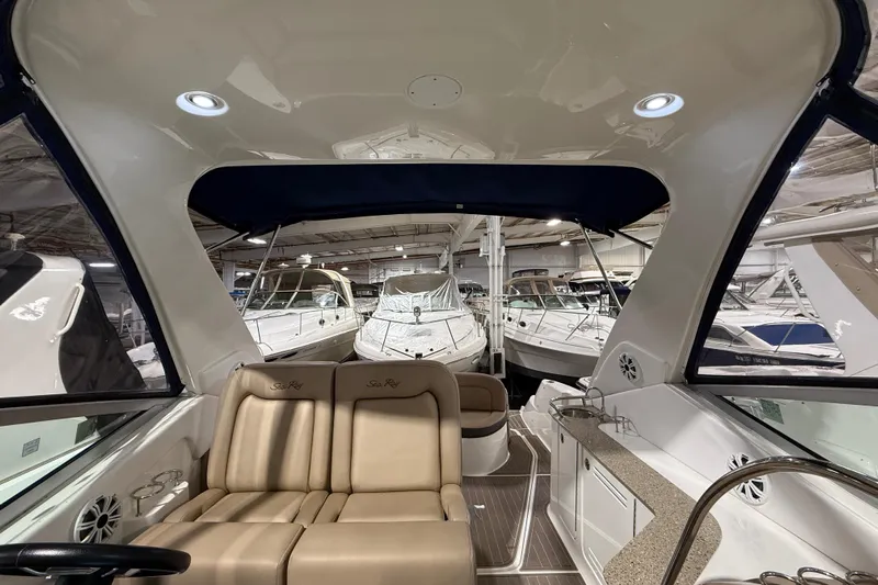  Yacht Photos Pics 2017 Sea Ray Sundancer 330 interior with beige seating and modern amenities in a showroom.