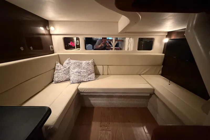  Yacht Photos Pics Luxurious interior of 2017 Sea Ray Sundancer 330 with beige seating and decorative pillows.