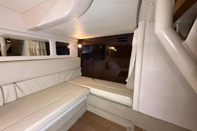  Yacht Photos Pics Interior of 2017 Sea Ray Sundancer 330 with beige seating and wall-mounted TV.