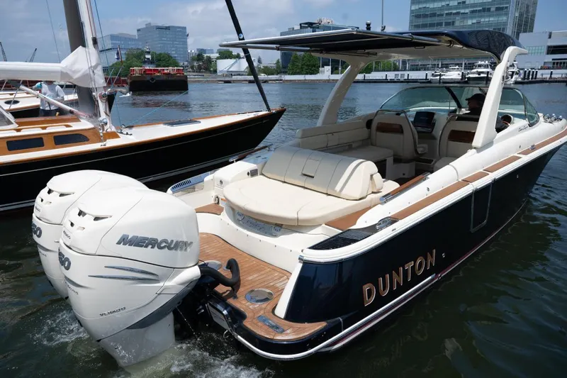 Dunton Yacht Photos Pics 2021 Chris-Craft Launch GT boat with twin Mercury engines docked in a marina.
