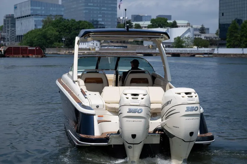 Dunton Yacht Photos Pics 2021 Chris-Craft Launch GT boat with twin 350 engines on a city waterfront.