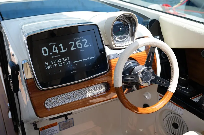 Dunton Yacht Photos Pics 2021 Chris-Craft Launch GT dashboard with GPS display and wooden steering wheel.