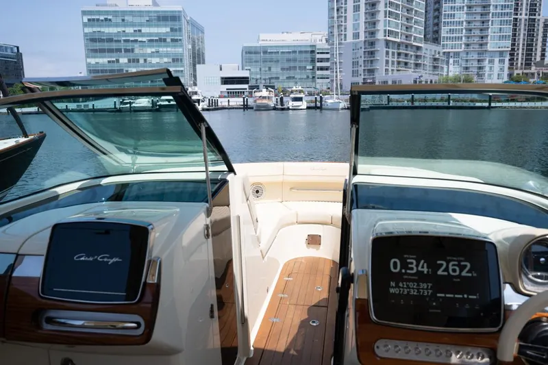 Dunton Yacht Photos Pics 2021 Chris-Craft Launch GT boat interior with cityscape background.