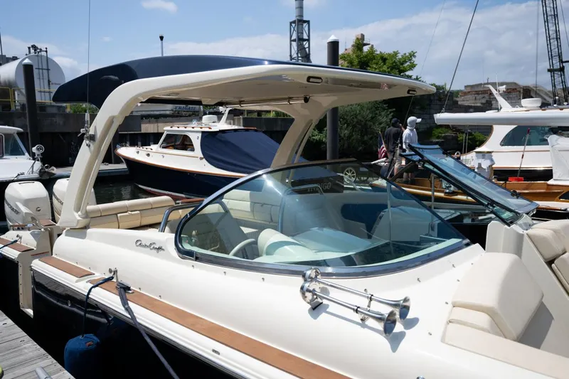 Dunton Yacht Photos Pics 2021 Chris-Craft Launch GT boat docked, featuring sleek design and luxurious interior.