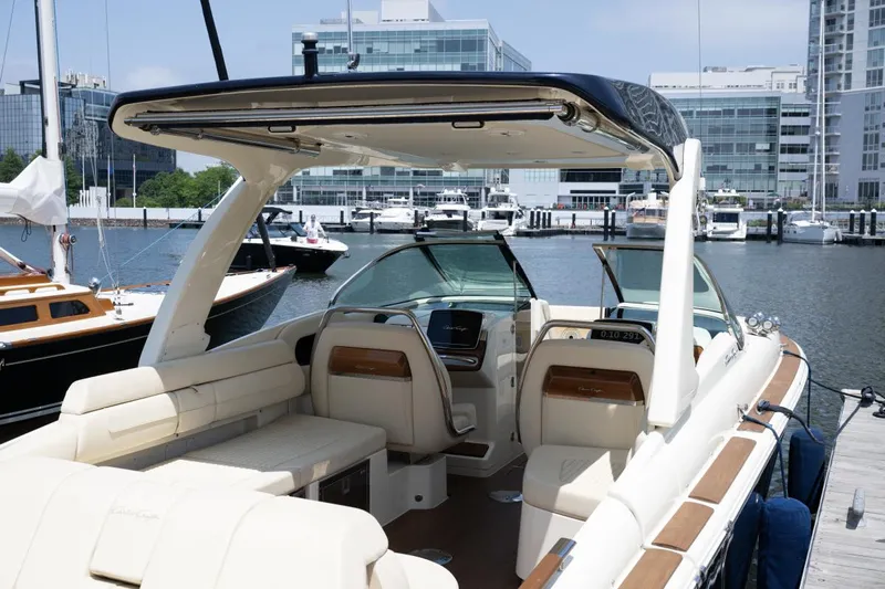 Dunton Yacht Photos Pics 2021 Chris-Craft Launch GT boat with luxurious seating, docked in a modern marina.
