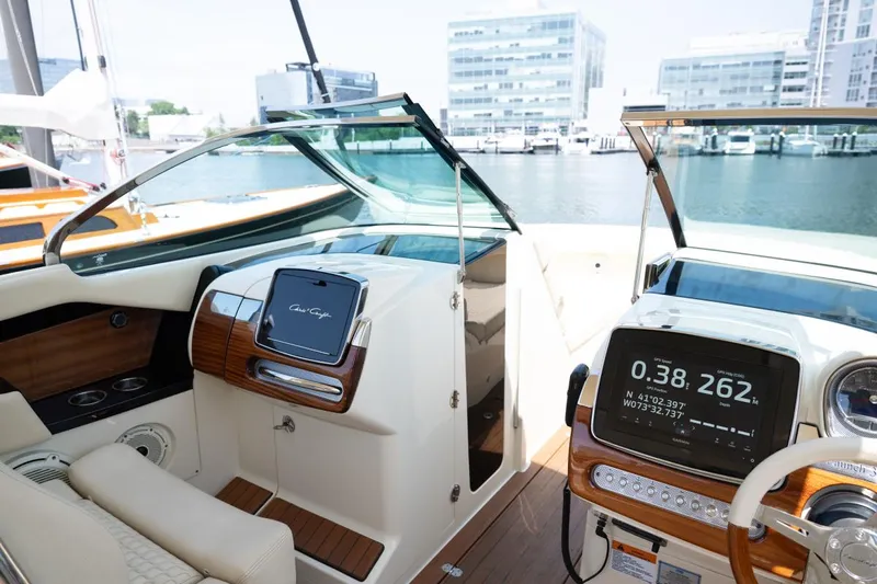 Dunton Yacht Photos Pics 2021 Chris-Craft Launch GT boat interior with modern dashboard and waterfront view.