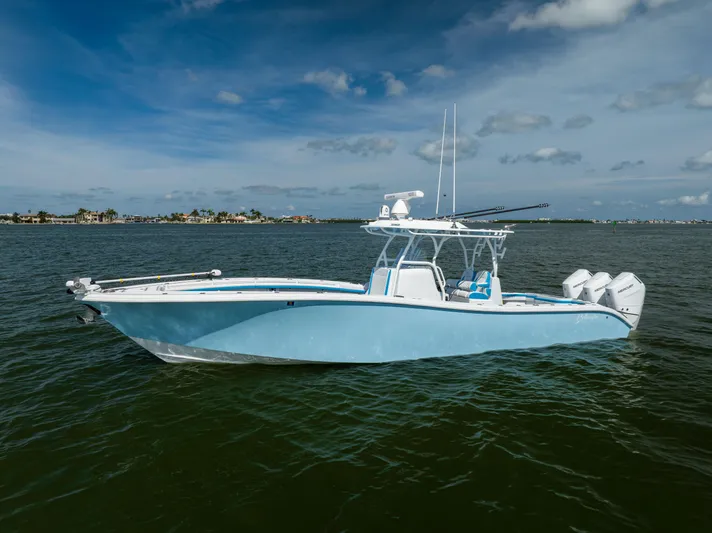 Yacht Photos Pics 2023 Yellowfin 36 Offshore boat on calm water under blue sky.