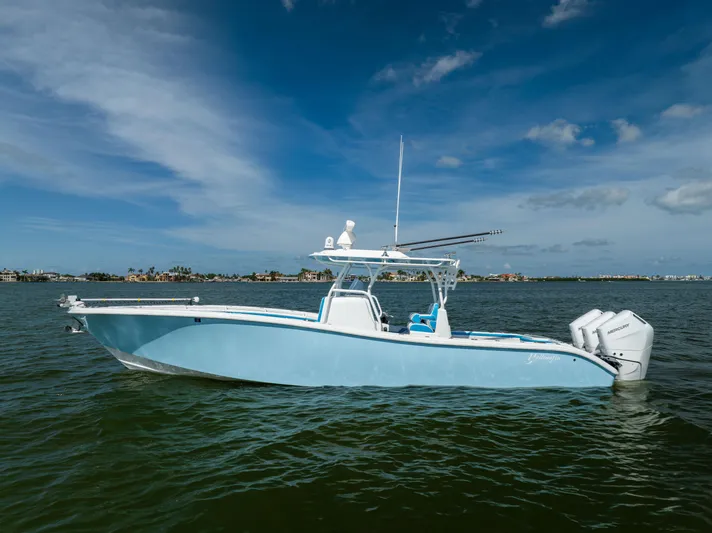  Yacht Photos Pics 2023 Yellowfin 36 Offshore boat on calm water under a clear blue sky.