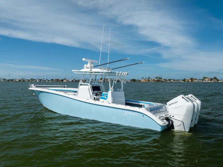  Yacht Photos Pics 2023 Yellowfin 36 Offshore boat on calm water, featuring triple Mercury engines.