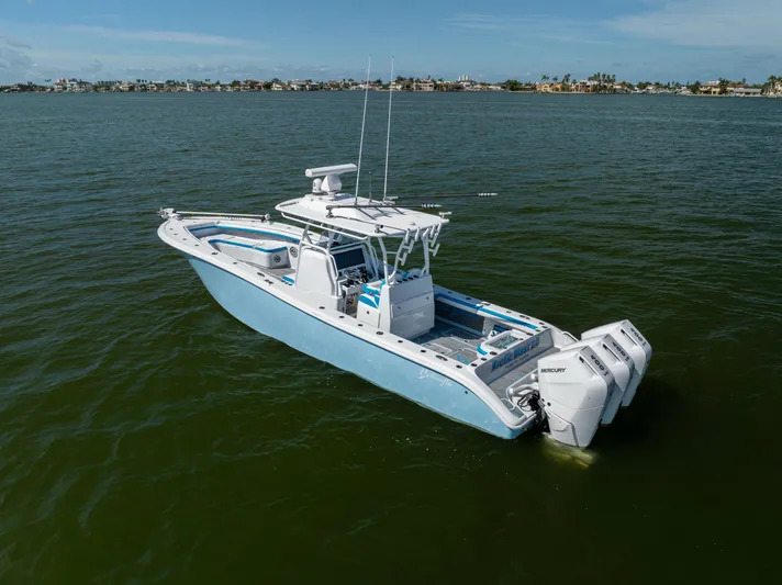  Yacht Photos Pics 2023 Yellowfin 36 Offshore boat on calm water, featuring triple Mercury engines.