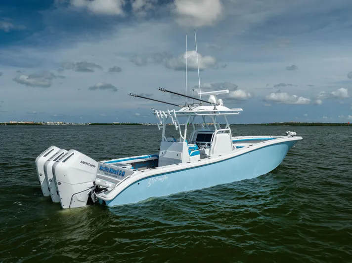  Yacht Photos Pics 2023 Yellowfin 36 Offshore boat with triple Mercury engines on open water.