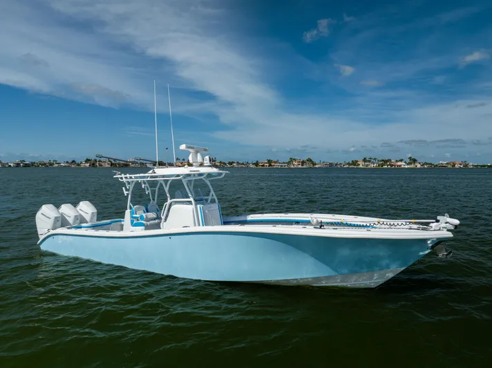  Yacht Photos Pics 2023 Yellowfin 36 Offshore boat on calm water under blue sky.