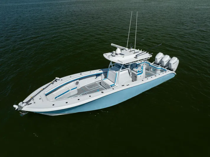  Yacht Photos Pics 2023 Yellowfin 36 Offshore boat on open water, featuring triple outboard engines.