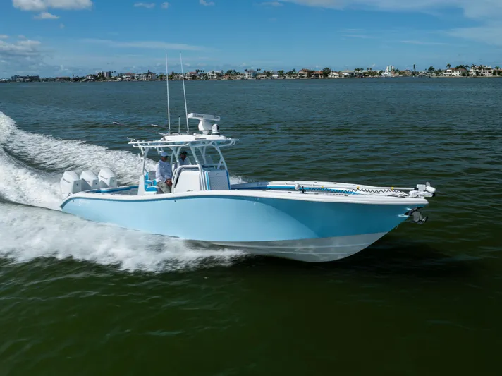  Yacht Photos Pics 2023 Yellowfin 36 Offshore boat cruising on open water under a clear blue sky.