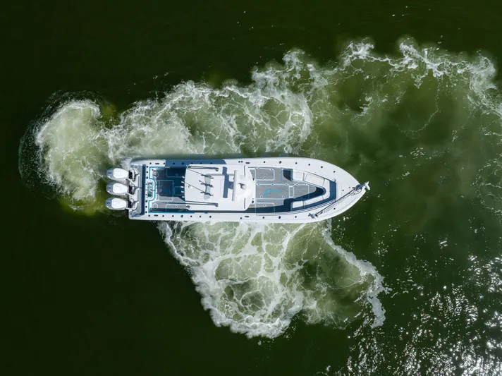  Yacht Photos Pics Aerial view of 2023 Yellowfin 36 Offshore boat navigating through green waters.