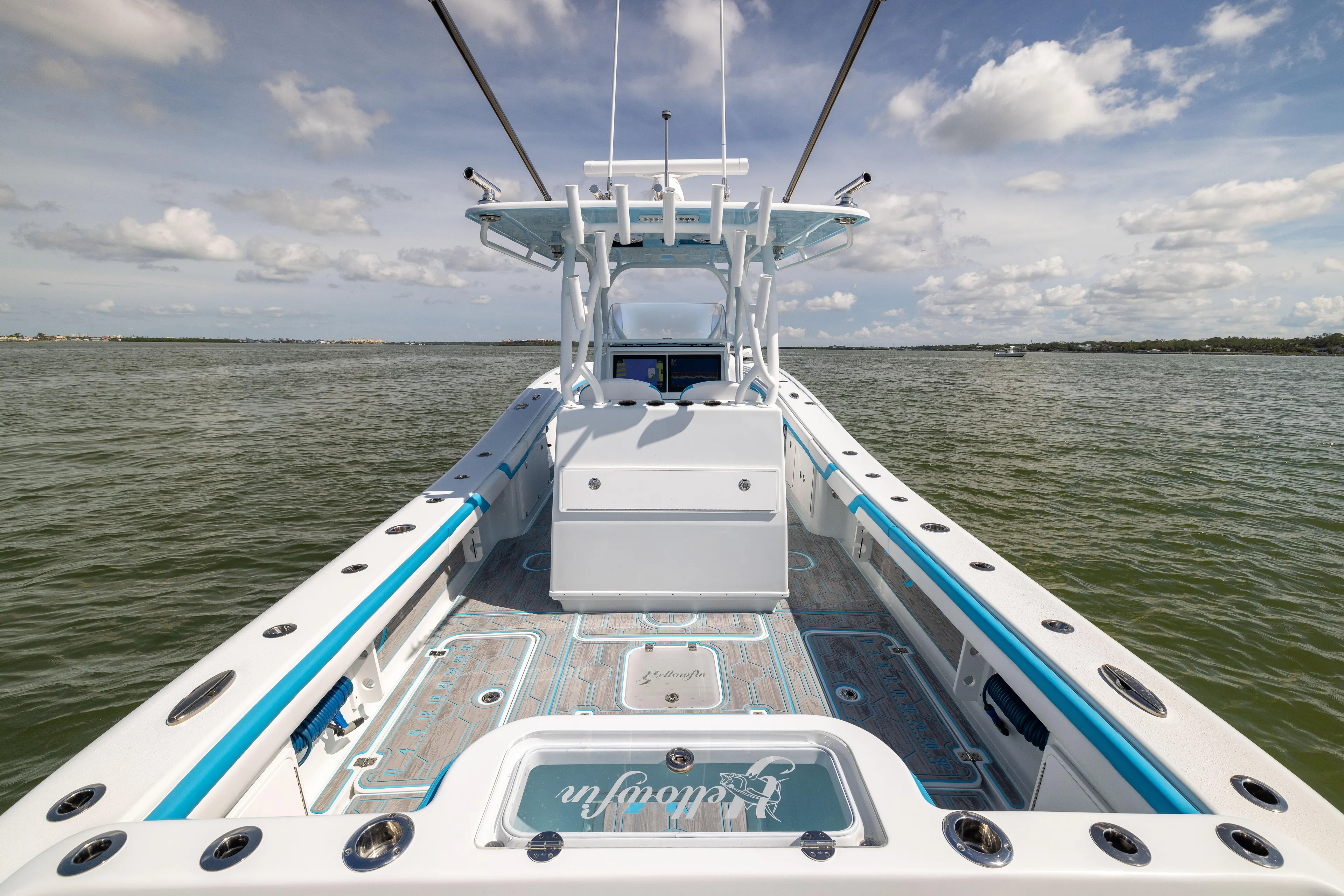  Yacht Photos Pics 2023 Yellowfin 36 Offshore boat on calm water under a partly cloudy sky.