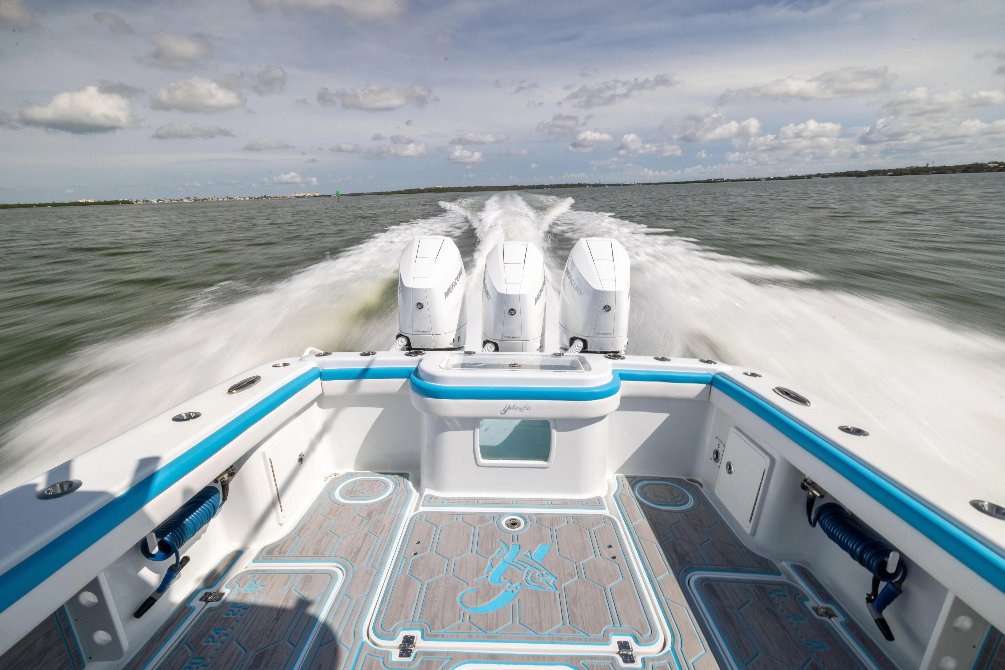  Yacht Photos Pics 2023 Yellowfin 36 Offshore boat speeding on open water, showcasing powerful engines.