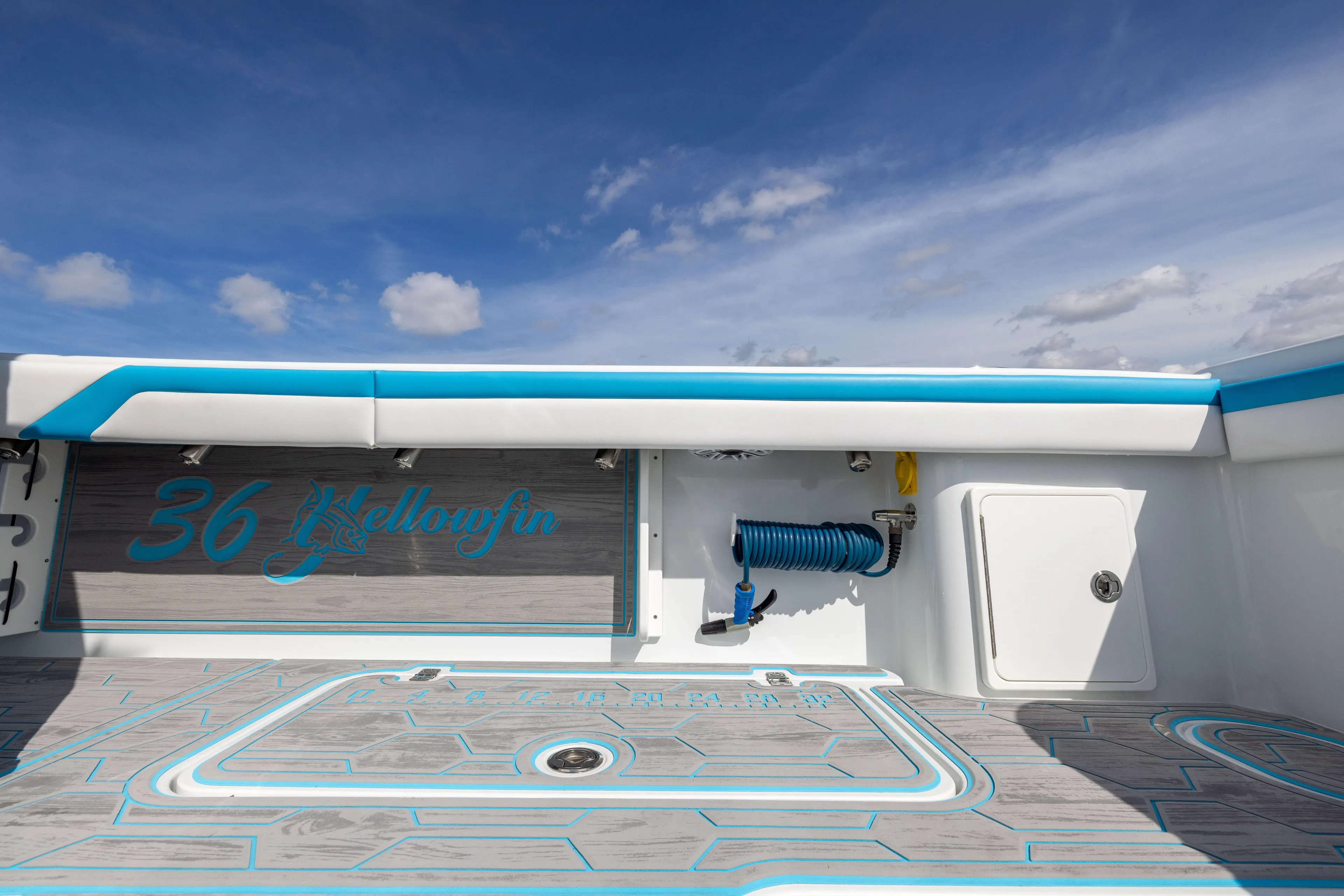  Yacht Photos Pics 2023 Yellowfin 36 Offshore boat deck with blue accents under a clear sky.