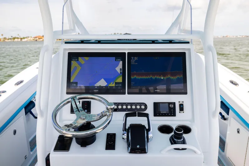  Yacht Photos Pics 2023 Yellowfin 36 Offshore boat dashboard with navigation screens and steering wheel.