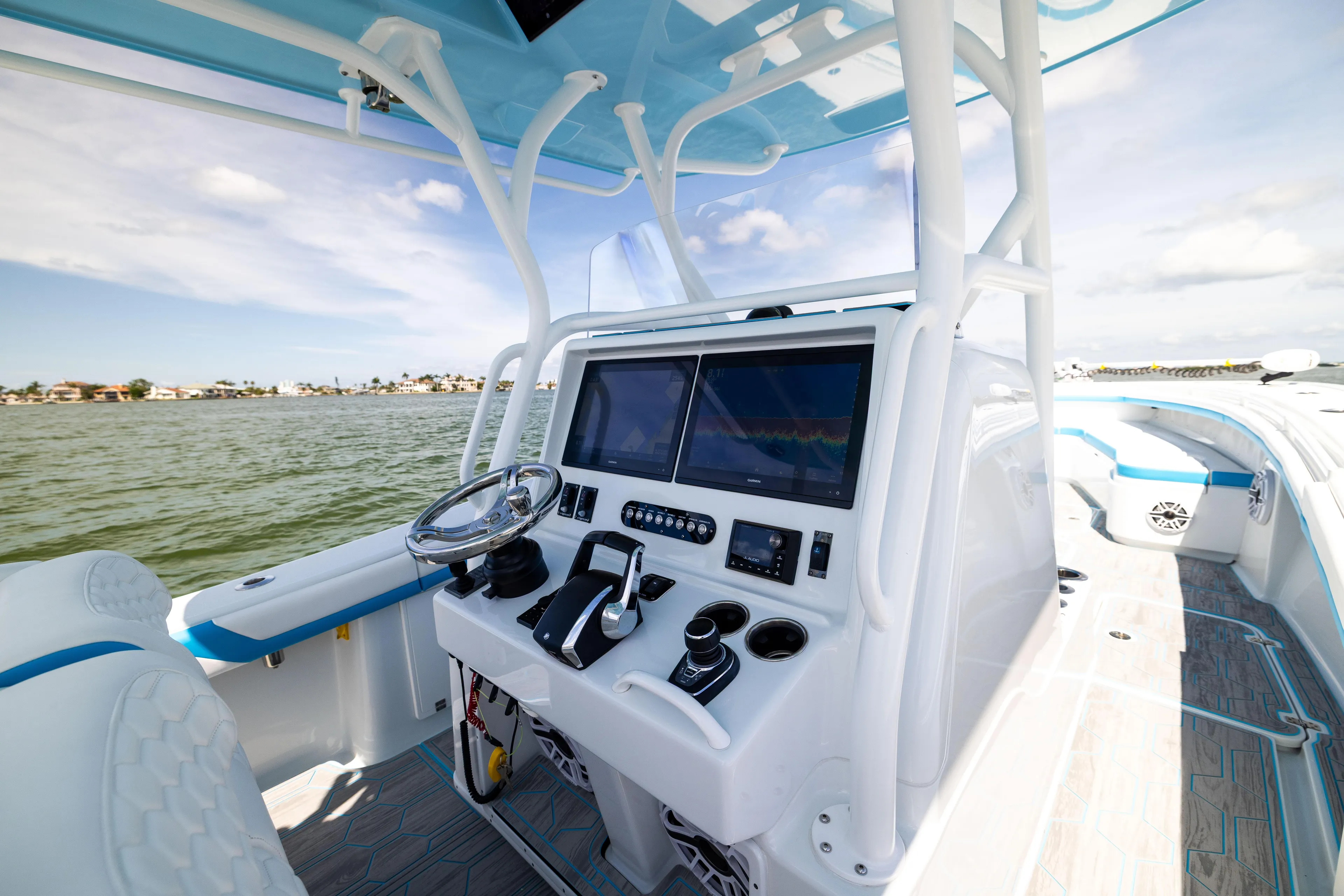  Yacht Photos Pics 2023 Yellowfin 36 Offshore boat cockpit with advanced navigation system and steering wheel.