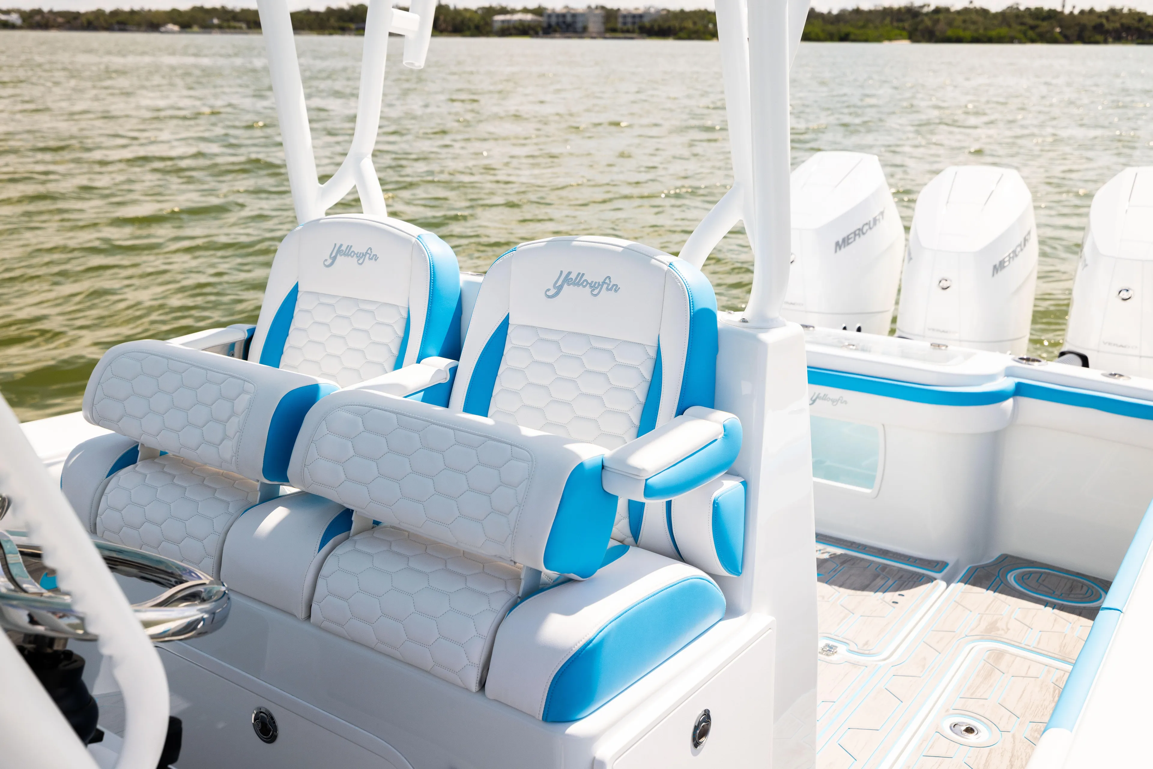  Yacht Photos Pics 2023 Yellowfin 36 Offshore boat interior with blue and white seating, featuring Mercury engines.