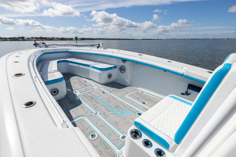  Yacht Photos Pics 2023 Yellowfin 36 Offshore boat interior with blue accents, spacious seating, and ocean view.