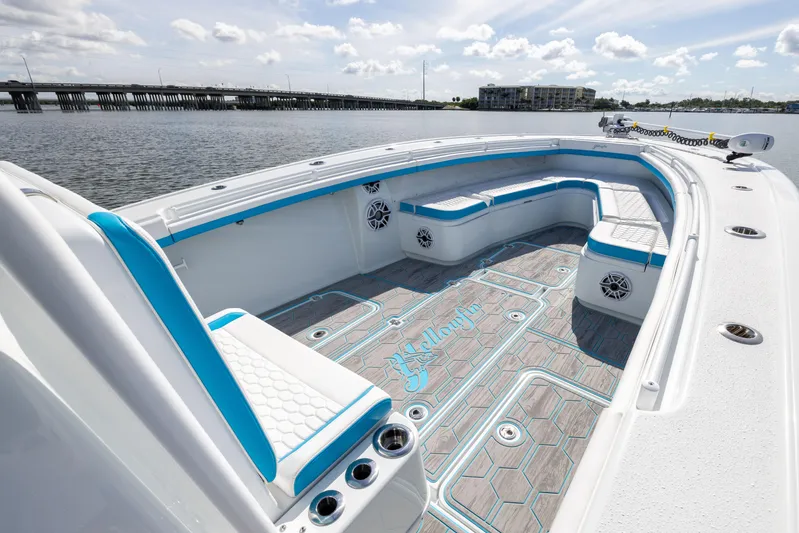  Yacht Photos Pics 2023 Yellowfin 36 Offshore boat interior with blue accents, spacious seating, and scenic water view.