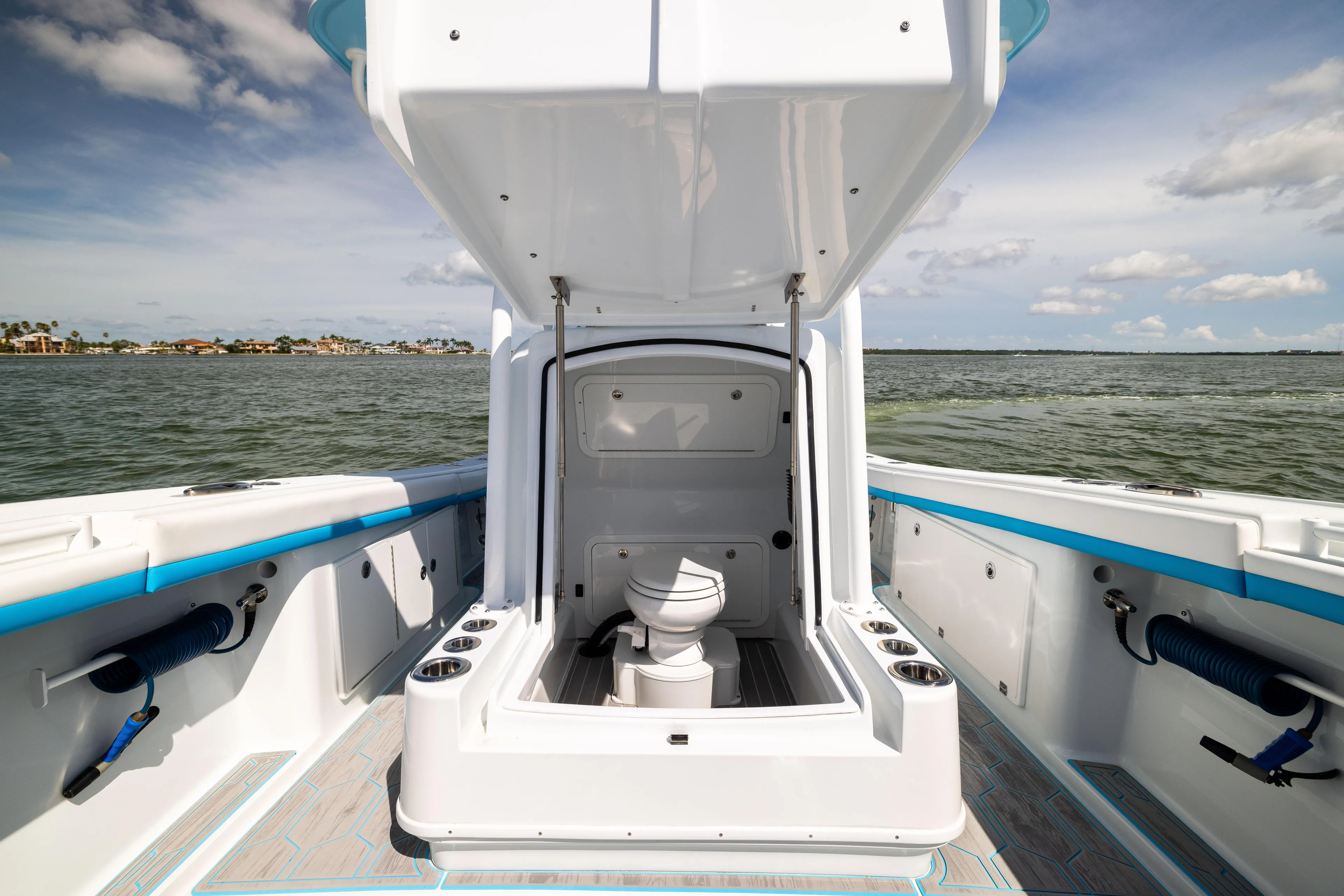  Yacht Photos Pics 2023 Yellowfin 36 Offshore boat interior with open hatch and toilet, ocean view.