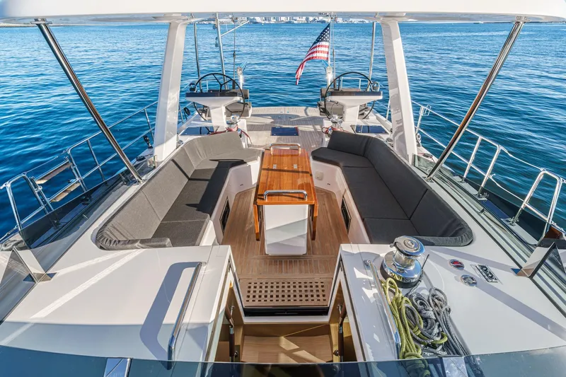  Yacht Photos Pics Luxurious 2025 Hylas H57 yacht deck with seating, table, and ocean view.