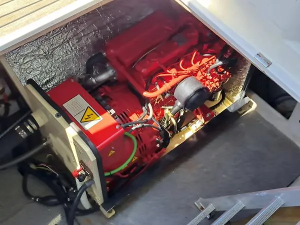 Kungaloosh Yacht Photos Pics Engine compartment of a 2010 Fountaine Pajot Cumberland 46, showcasing a red marine engine.