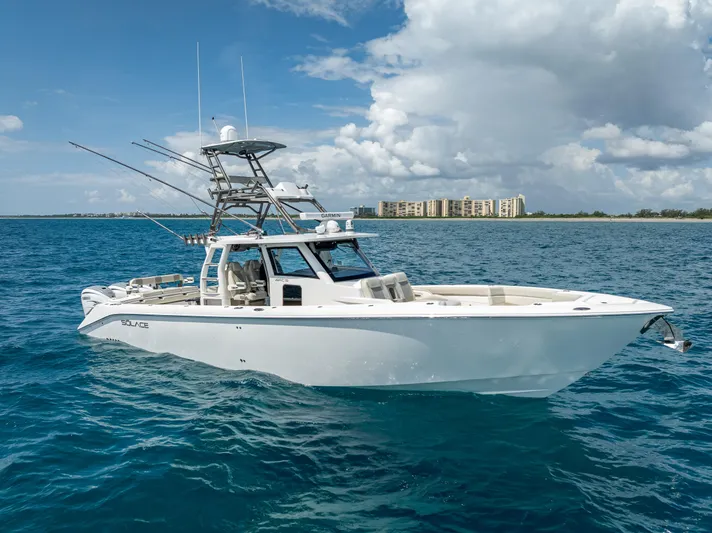 Two Roads Yacht Photos Pics 2021 Solace 41CS boat on blue ocean with clear sky and distant buildings.