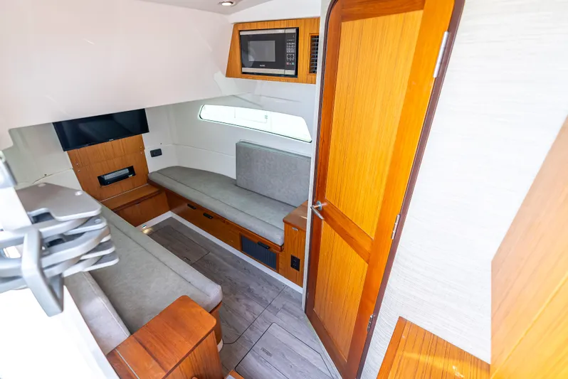 Two Roads Yacht Photos Pics Interior of 2021 Solace 41CS boat with modern seating and wooden accents.