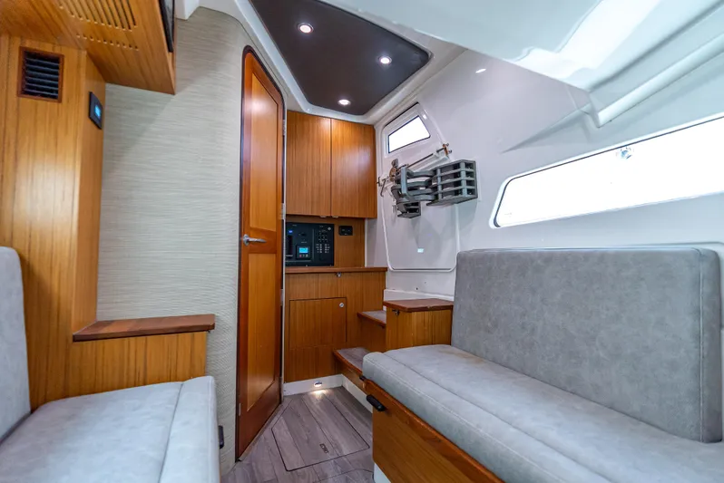 Two Roads Yacht Photos Pics Interior of 2021 Solace 41CS boat with modern wood finish and seating area.