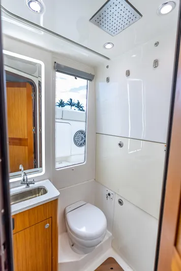 Two Roads Yacht Photos Pics Luxurious bathroom in 2021 Solace 41CS boat, featuring modern fixtures and natural light.