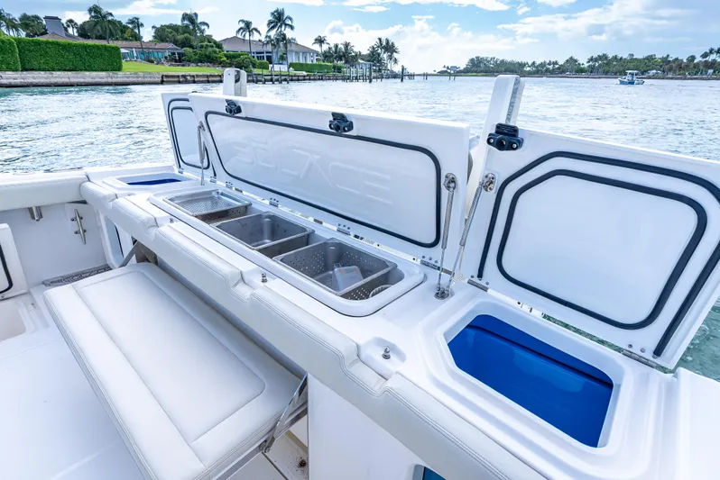 Two Roads Yacht Photos Pics 2021 Solace 41CS boat with open storage compartments, docked by a scenic waterfront.