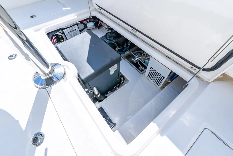 Two Roads Yacht Photos Pics Open hatch of 2021 Solace 41CS boat showing internal components and storage area.