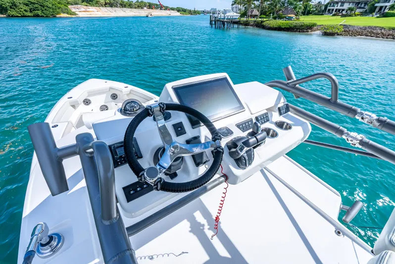 Two Roads Yacht Photos Pics Helm of 2021 Solace 41CS boat with steering wheel and controls on blue water.