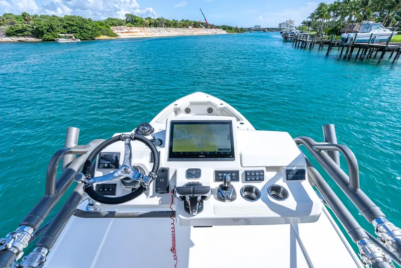 Two Roads Yacht Photos Pics Helm of 2021 Solace 41CS boat with navigation screen, steering wheel, and controls on blue water.