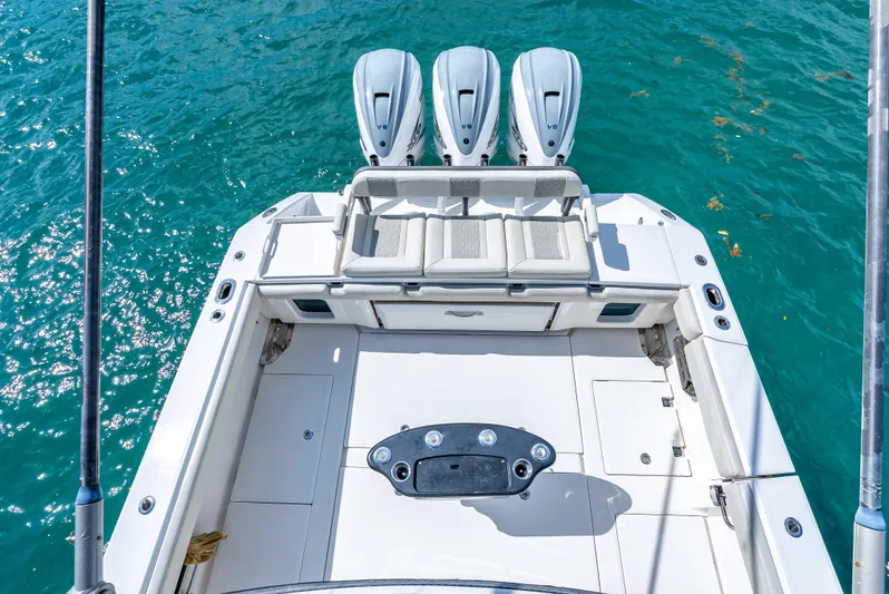 Two Roads Yacht Photos Pics 2021 Solace 41CS boat with triple engines on clear blue water.