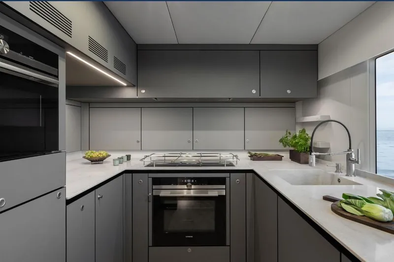  Yacht Photos Pics Modern kitchen interior on 2025 Sunreef Yachts 80 Eco, featuring sleek cabinetry and ocean view.