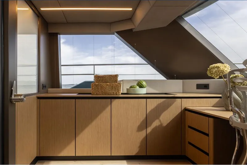  Yacht Photos Pics Modern kitchen interior of 2025 Sunreef Yachts 80 Eco, featuring sleek cabinetry and large windows.