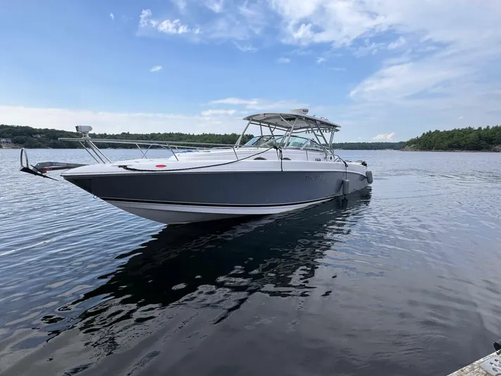  Yacht Photos Pics 2008 Donzi 38 ZSF boat on calm water under a partly cloudy sky.