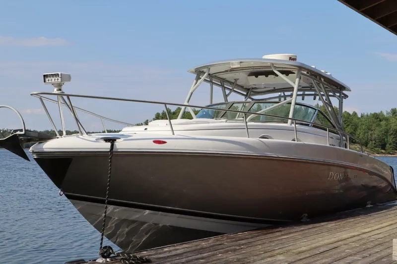  Yacht Photos Pics 2008 Donzi 38 ZSF boat docked on a serene lake with clear skies.