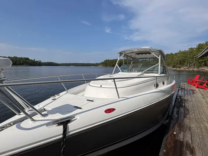  Yacht Photos Pics 2008 Donzi 38 ZSF boat docked by a serene lake with clear skies.