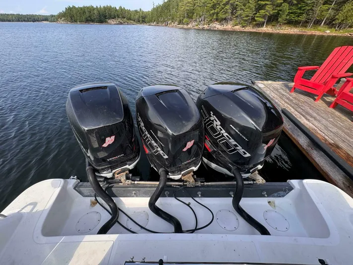  Yacht Photos Pics Triple Mercury outboard engines on a 2008 Donzi 38 ZSF boat by a dock.