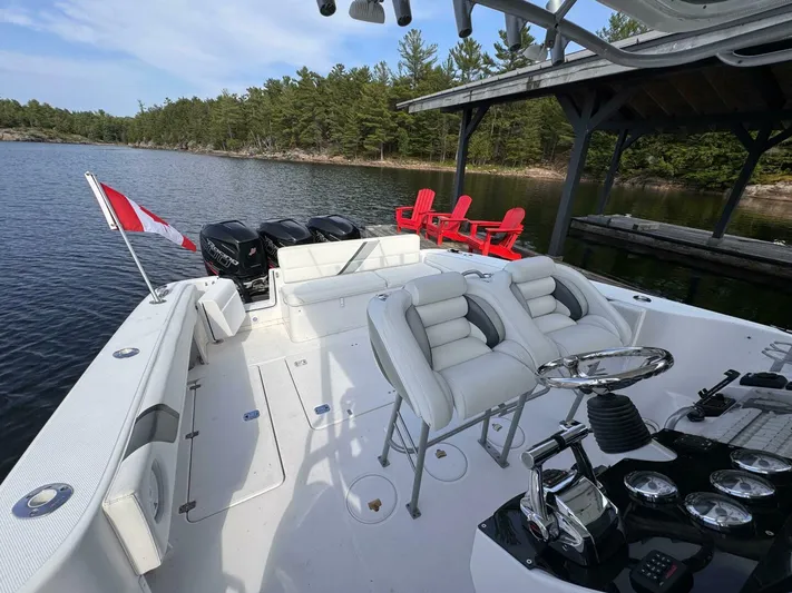  Yacht Photos Pics 2008 Donzi 38 ZSF boat with Canadian flag, docked near forested shoreline.
