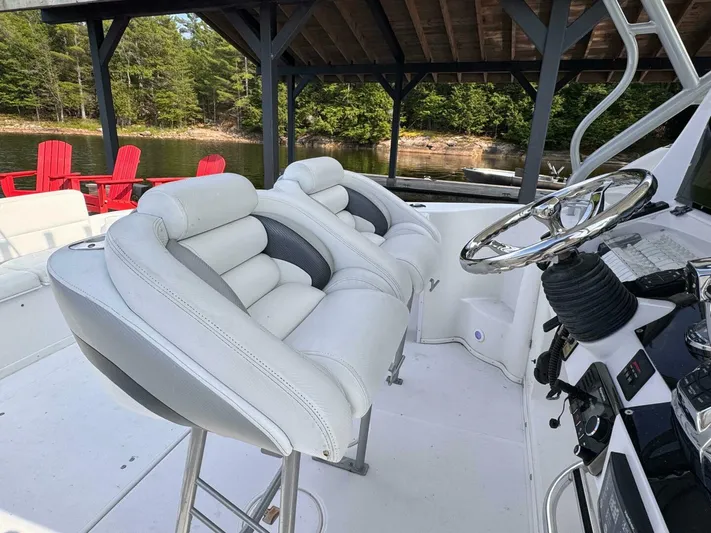  Yacht Photos Pics 2008 Donzi 38 ZSF boat interior with white seating and steering wheel, docked by a lake.