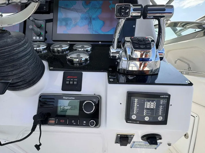  Yacht Photos Pics Control panel of a 2008 Donzi 38 ZSF boat with navigation and throttle controls.