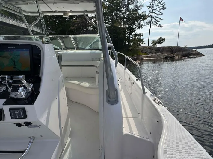  Yacht Photos Pics 2008 Donzi 38 ZSF boat interior with navigation system, docked by a scenic lakeside.